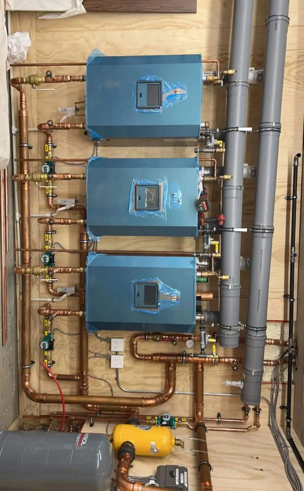 Modern high-efficiency boiler installation with copper piping and manifolds