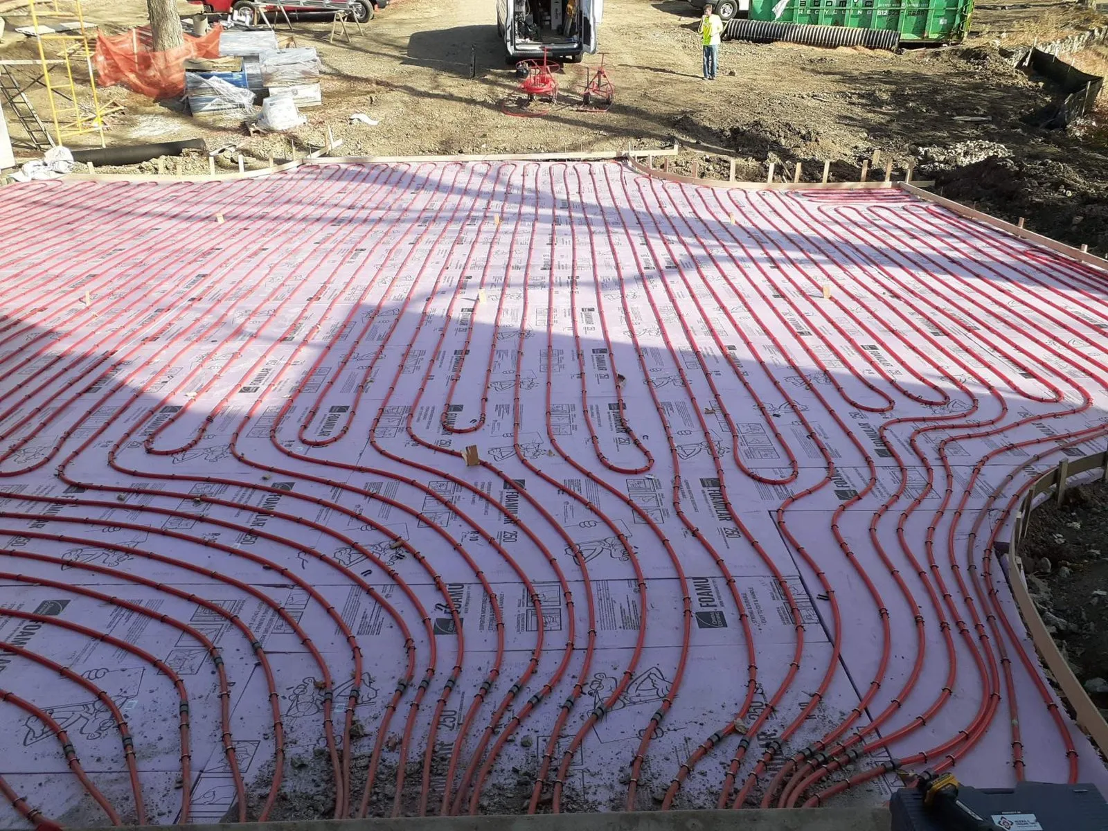 Snowmelt tubing laid out across a driveway before the concrete pour